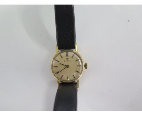 A 9ct yellow gold manual wind ladies wristwatch 18mm case on a leather strap 