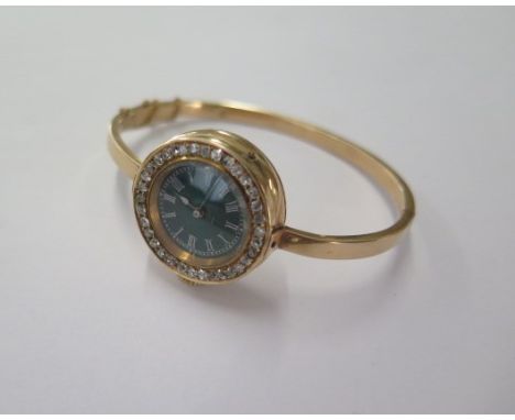 A diamond set gilt metal manual wind wristwatch on a later hollow hinged bangle - 25mm case - total weight approx 26.8 grams 