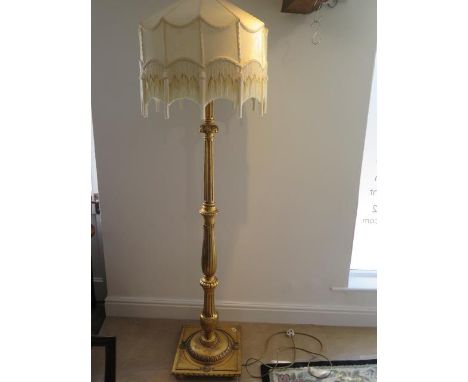 A gilt wood lamp and shade - in working order - Height 195cm 