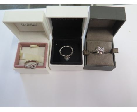 Two Pandora silver rings sizes K and L and a Clogau rolled gold ring size J - all generally good 