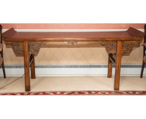 A Chinese altar table, late Qing Dynasty/Republic, the rectangular top with scroll ends above a shaped frieze carved with bat