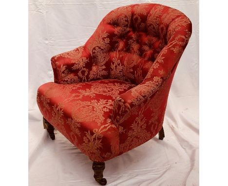 A Victorian and later mahogany framed upholstered button back armchair, floral damask upholstery, raised on turned mahogany f