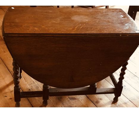 A George III oak gate leg dining table with barley twist legs