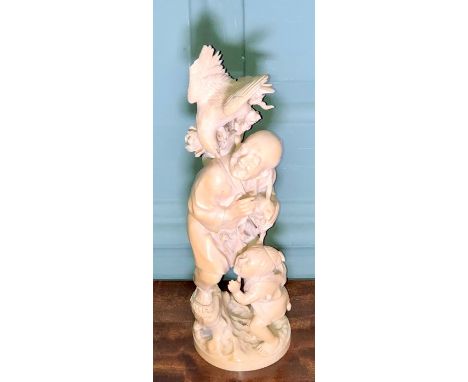 A Meji period carved ivory okimono, peasant and child looking at a bird on his back satchel, signed Kokoku. 30cm H