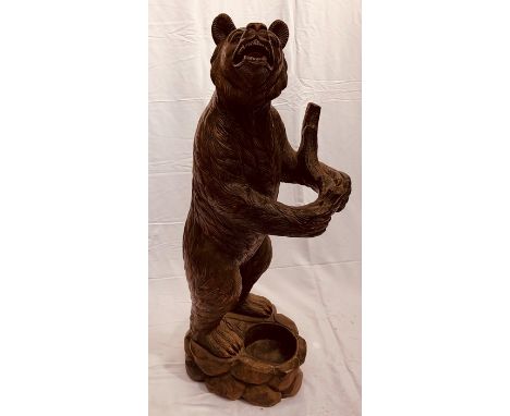 A Black Forest carved wooden Bear stick/umbrella stand, in form of a standing Bear holding a branch with glass eyes. 125cm H