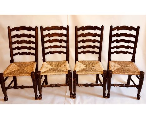 A set of twelve early 19th and later century elm rush seated chairs, circa 1810, ladder back with turned supports, raised on 
