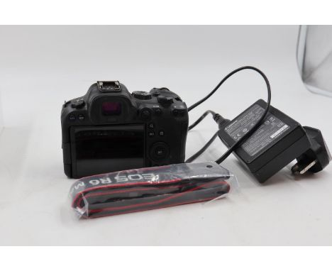 Canon EOS R6 MKII DSLR camera body with battery charger and unused shoulder strap. Powers on, appears to be functioning. UK P