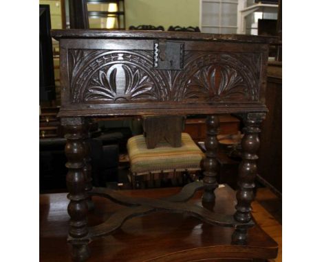 A 17TH CENTURY DESIGN OAK BOX TOPPED SIDE TABLE , with probably later carved front, supported on short bobbin turned legs, un