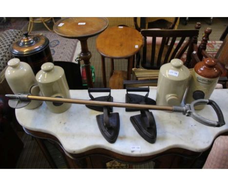 A METAL SHAFTED SHOOTING STICK, four flat irons and four stoneware hot water bottles 