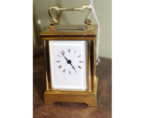 A VERY SMALL SIZED BRASS CASED CARRIAGE CLOCK 