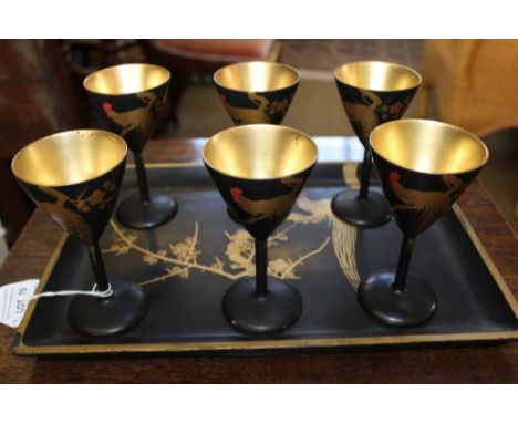 A 20TH CENTURY JAPANESE LACQUER SAKI SET, comprising tray 30cm x 21cm, black ground with gilded cockerel design, with a match
