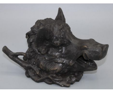 After Barrie - a patinated cast metal inkwell in the form of a boars head, with hinged jaw and naturalistic branch work pen r