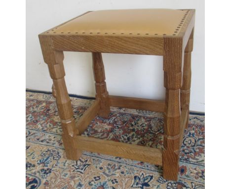 Robert Mouseman Thompson of Kilburn - an oak dressing table stool, nailed cowhide upholstered top, on octagonal baluster supp