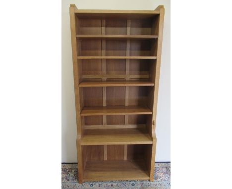 Robert Mouseman Thompson of Kilburn - an oak waterfall bookcase, panelled back with four adjustable and one fixed shelves, ca