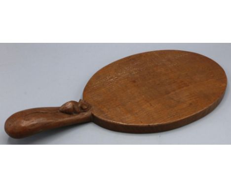 Robert Mouseman Thompson of Kilburn - an oak oval cheese board, the handle carved with signature mouse, L36.5cm