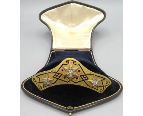 Victorian hair slide with gilt metal mount hinged to the comb decorated with black enamel and raised stars with clear diamant