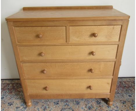 Robert Mouseman Thompson of Kilburn - a panelled oak chest of two short and three long drawers with adzed top on octagonal ba