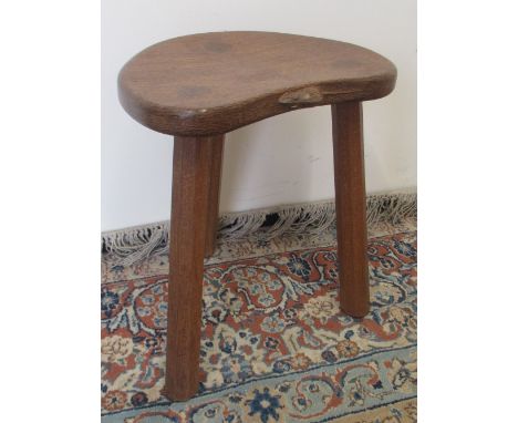 Robert Mouseman Thompson of Kilburn - an oak kidney shaped stool, on three faceted outsplayed supports, carved with signature