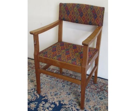 Robert Mouseman Thompson of Kilburn - an oak open arm chair, with nailed upholstered back and seat on square tapered supports