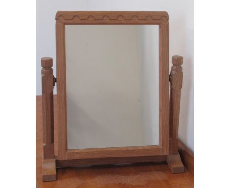 Robert Mouseman Thompson of Kilburn - an oak toilet mirror, rectangular plate with penny moulded frieze on octagonal supports