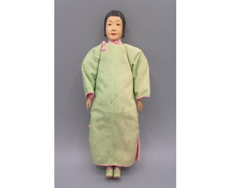 Chinese 'Door of Hope' doll 1930s, carved pearwood, modelled as a woman in green robe, H28cm