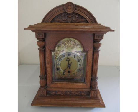 Early 20th Century German oak bracket clock, carved and moulded case with 3/4 fluted pilasters, break arch bevel edged glazed