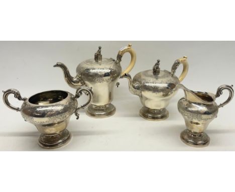 William IV silver four piece pear shaped coffee and tea service, chased Chinoiserie decoration, the tea and coffee pot with i