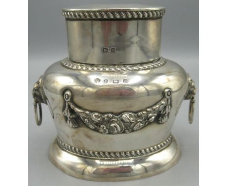 George V silver tea caddy and cover, ovoid body with floral swag, gadrooned borders and lion mask and ring handles, with gilt