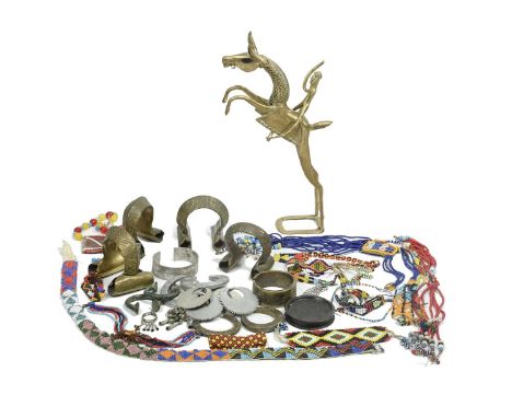 An Ethiopian clay lip plate8.3cm diameter,a collection of brass, bronze and aluminium bangles and earrings, a Nigerian brass 