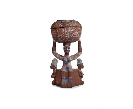 A Yoruba shrine bowl arugba shangoNigeriathe seated woman with a lip plug and raised arms supporting a covered bowl, relief c