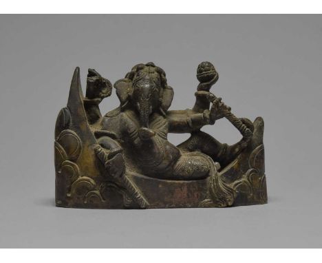 An Indian bronze ganeshcast reclining on a crescent moon and clouds, 7.8cm high.
