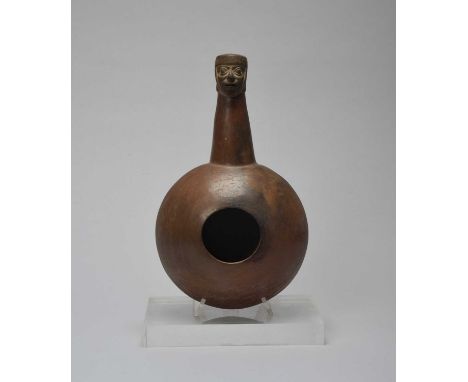 A Moche dipper vesselPeru, circa 100 - 600 ADpottery, with a compressed circular bowl and a tapered handle with a man's head 