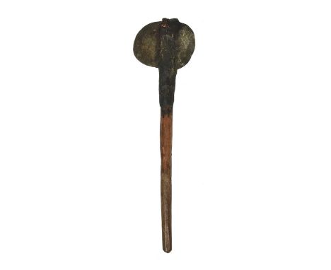 An Aboriginal axeAustraliawith a large stone blade attached to a wooden shaft with fibre and gum binding,80cm long.