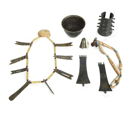 Seven Naga heirloom ornamentsNagalandincluding a bronze arm cuff, with spiral decoration and button protrusions, 11cm long, a