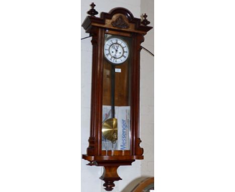 A 19th century walnut cased Vienna Regulator with white enamel dial and double weight driven striking movement
