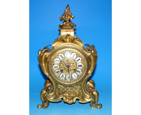 A 19th century ormolu mantel clock in rococo case, with scrolls, acanthus, etc., white enamel numerals, French drum movement 