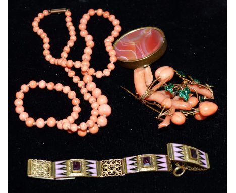 A coral and green enamel leaf brooch; a coral necklace; an enamelled and jewelled bracelet; an agate brooch