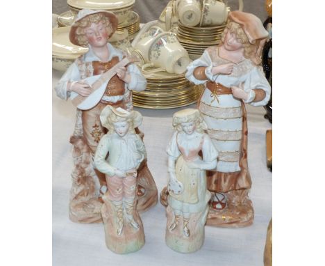 A pair of Victorian bisque figures: boy playing a lute, and dancing girl, 13"; a pair of similar smaller figures