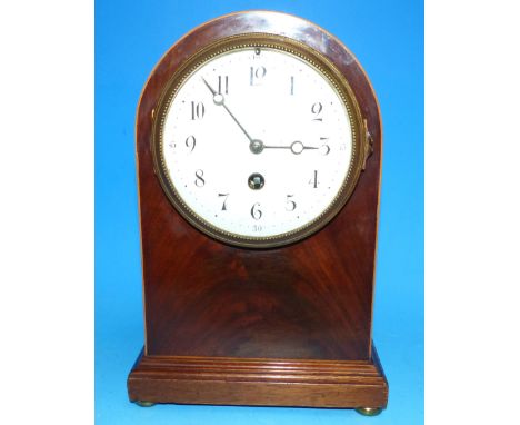 An Edwardian inlaid figured mahogany arch top mantel clock with white enamel dial and French drum movement, height 10½"