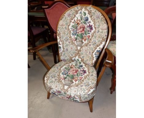 An Ercol stick back armchair with tapestry upholstery