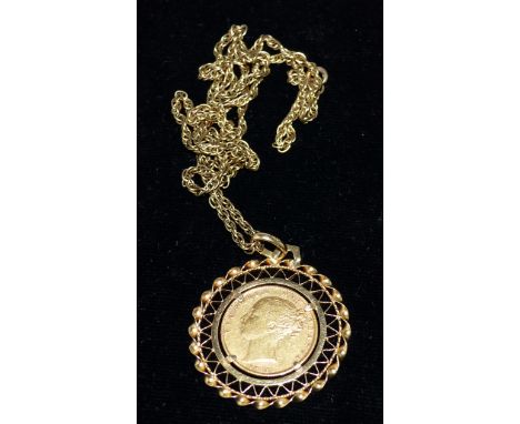 An 1873 sovereign in ornate pierced rope twist clip mount, stamped '750', gross 13.6 gm, on chain stamped '9CT', 8.7 gm