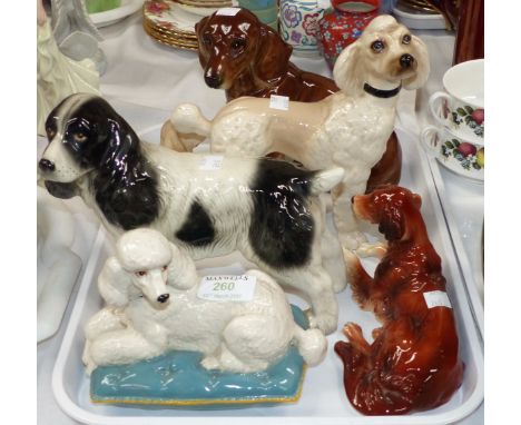 A Royal Doulton poodle on cushion; similar dog figures