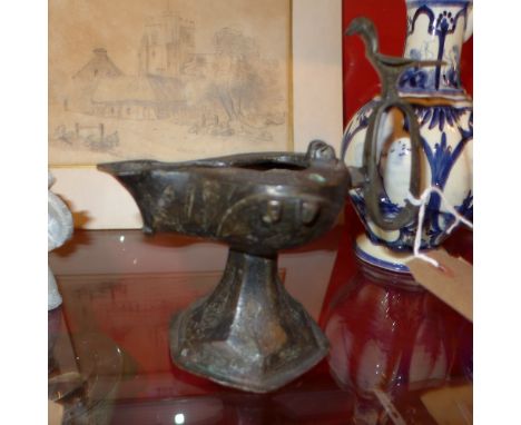 A Khorasan oil lamp on spreading trumpet foot, with hexagonal base, the flat topped rounded body of drop form extruded into a