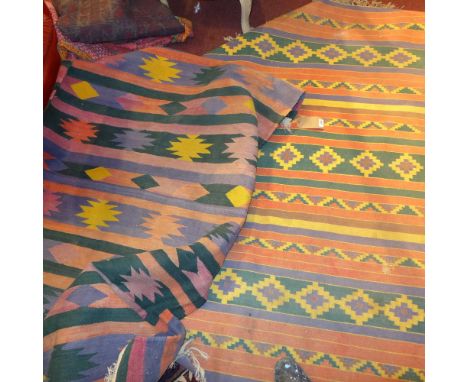 A collection of five rugs to include two modern kilim's together with a bed spread. 