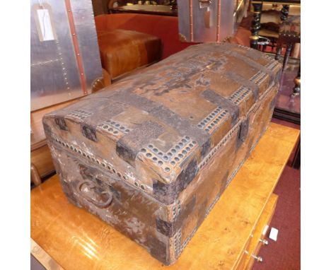 A Victorian cow hide trunk, iron bound with studding and iron handles. H-32cm W-69cm D-37cm