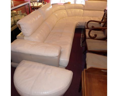 A contemporary white leather corner sofa with matching stool