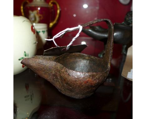 A Khorasan iron oil lamp of simple bowl form with extruded rectangular trough sprout, the angled flat section handle pierced 