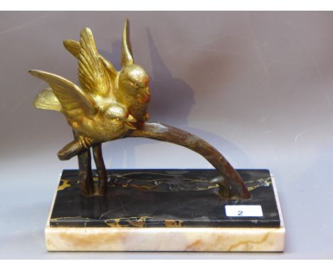 An Art Deco gilt bronze figural group of two birds on a branch, raised on marble base. 