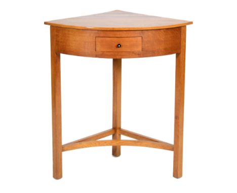 Joseph Serlin and Sons Ltd - An oak bow-fronted corner table with two inlaid diagonal hardwood bands to the top, fitted with 