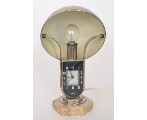 Mofem -  An Art Deco Mofem nickel plated bedside lamp with integral alarm clock on veined marble base below domed hemisphere 